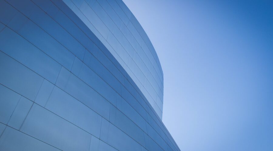 Curved blue glass office building