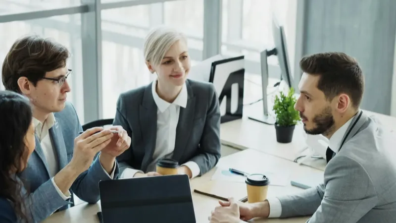 Colleagues in a meeting with a laptop and tablet