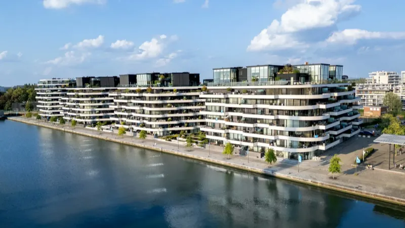 Residential buildings on the waterfront under a blue sky